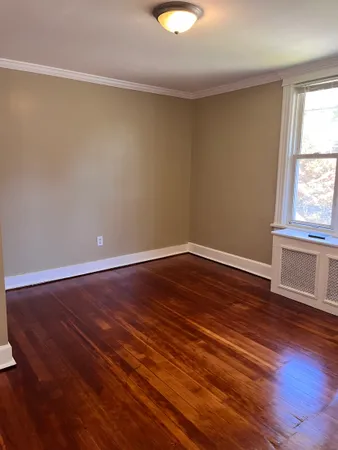 a view of a room with wooden floor and window