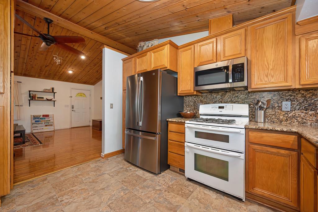 5415 Robert Road Pollock Pines, CA 95726 - Photo 21 of 72 a kitchen with stainless steel appliances granite countertop a refrigerator stove and microwave