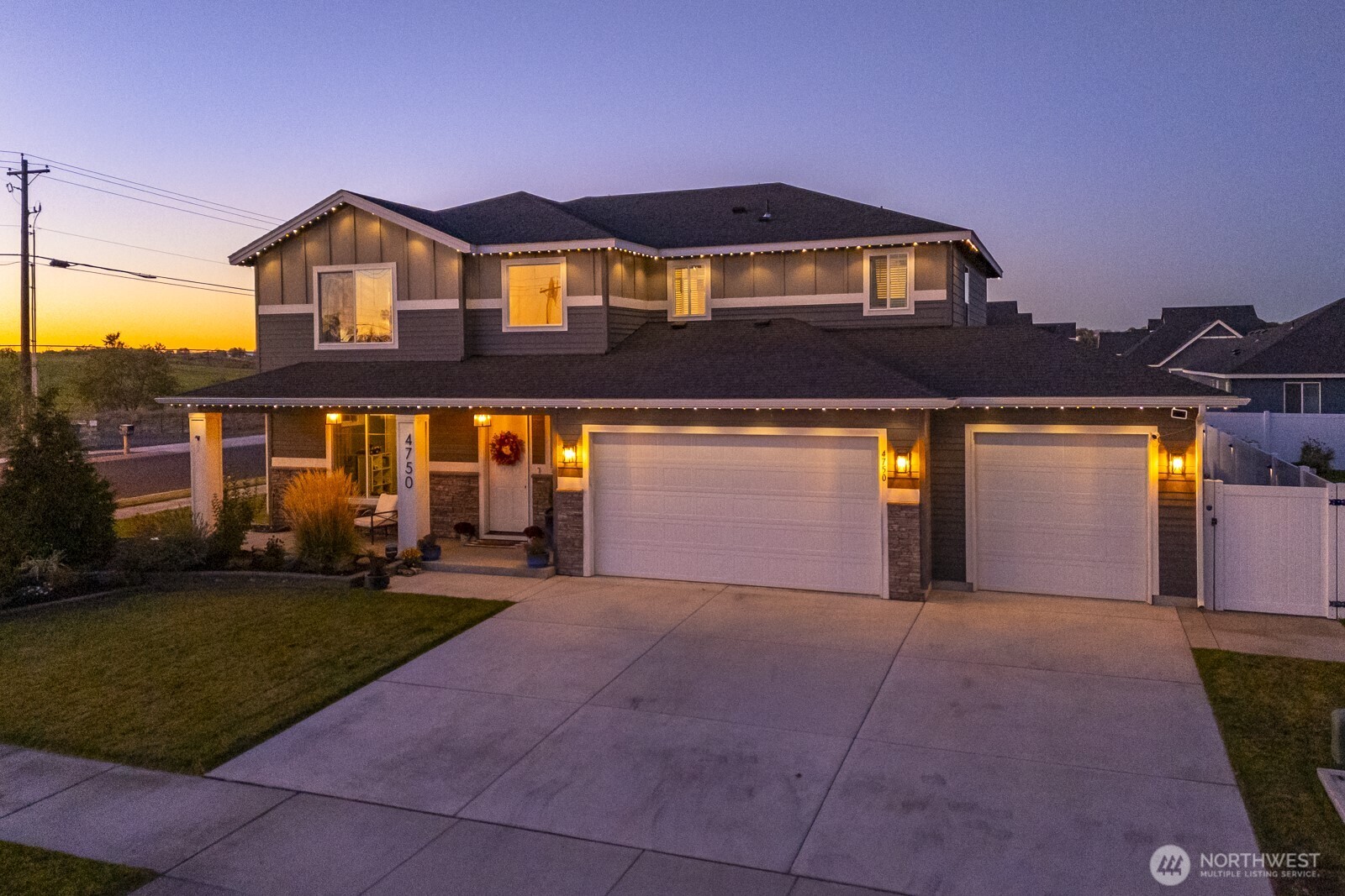 4750 Hawk Street Moses Lake, WA 98837 - Photo 2 of 35 a front view of a house with a yard and garage