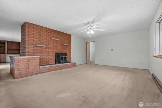 a view of empty room with fireplace