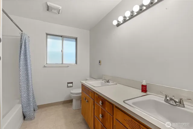 a bathroom with a sink a vanity and a toilet