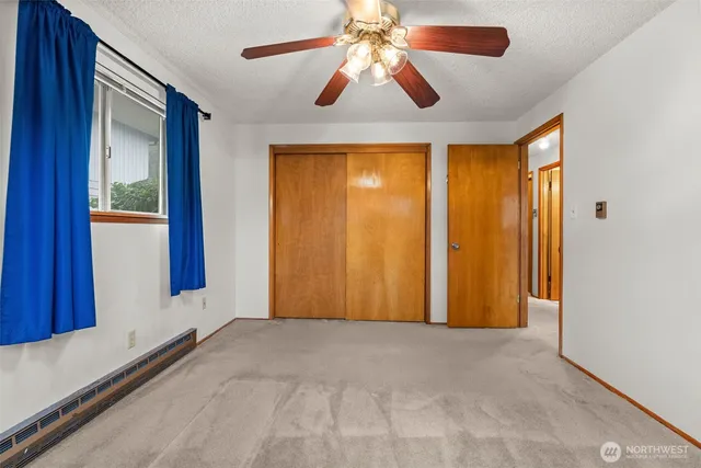 a view of room with a ceiling fan and a large window