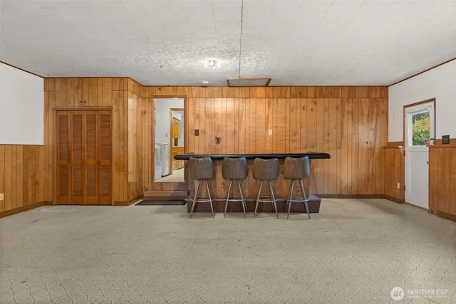 an empty room with a table and chairs