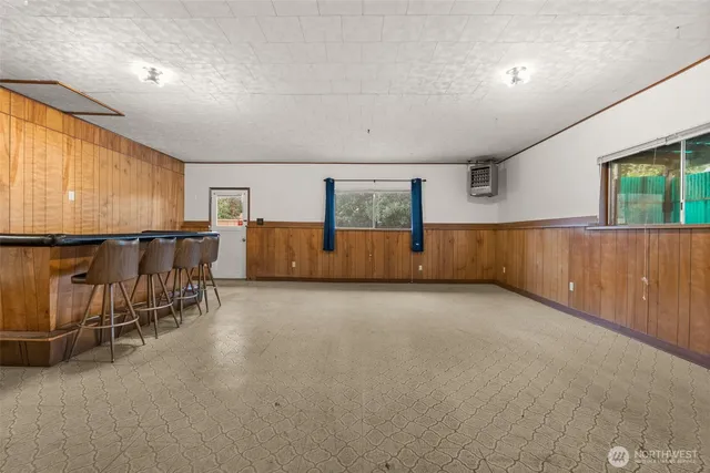 an empty room with furniture and windows