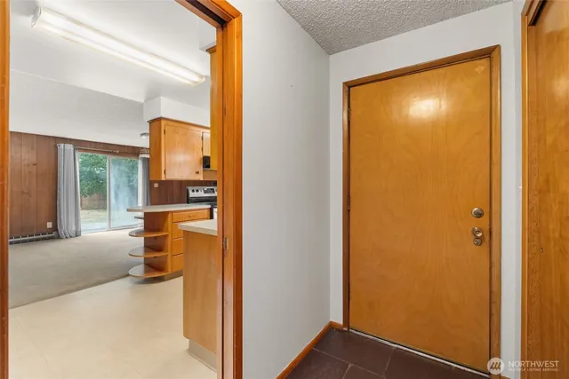 a view of a porch with a door and wooden floor