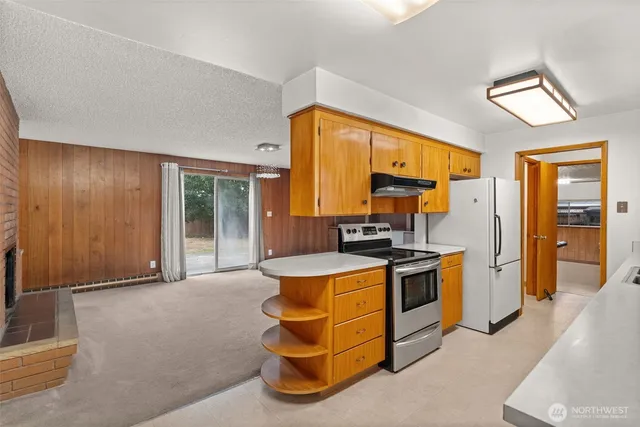 a kitchen with stainless steel appliances granite countertop a stove and a refrigerator