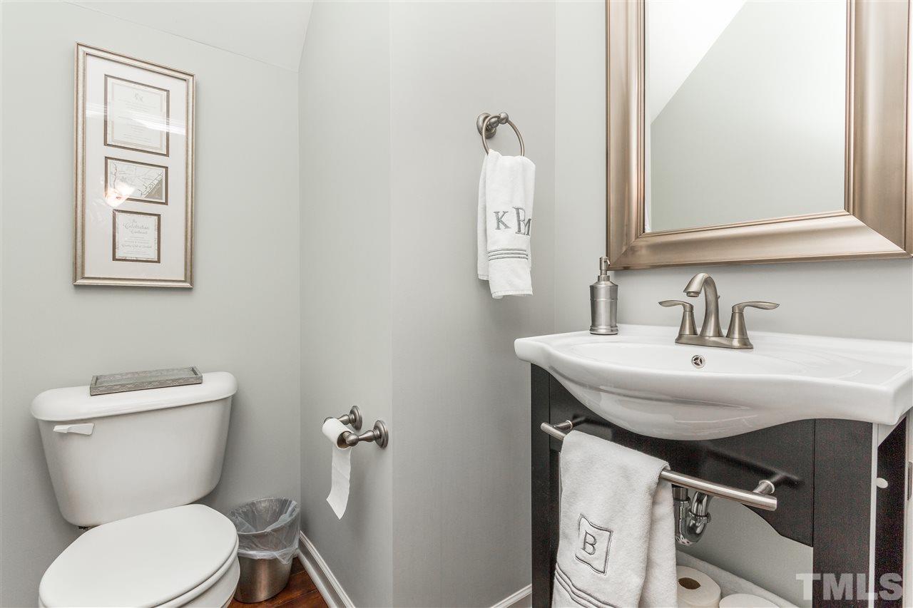 1325 Rodessa Run Raleigh, NC 27607 - Photo 12 of 25 a bathroom with a toilet a sink and mirror