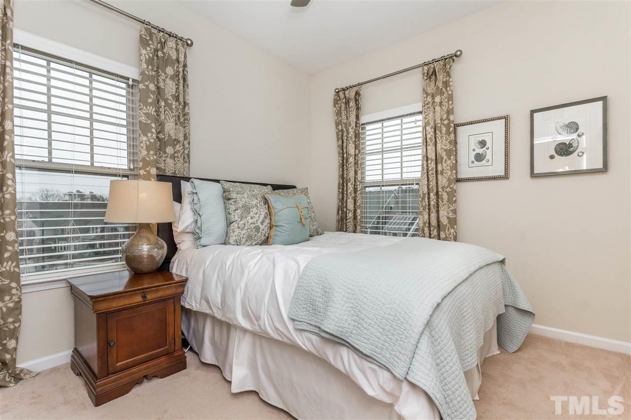 1325 Rodessa Run Raleigh, NC 27607 - Photo 18 of 25 a bedroom with a bed and wooden floor