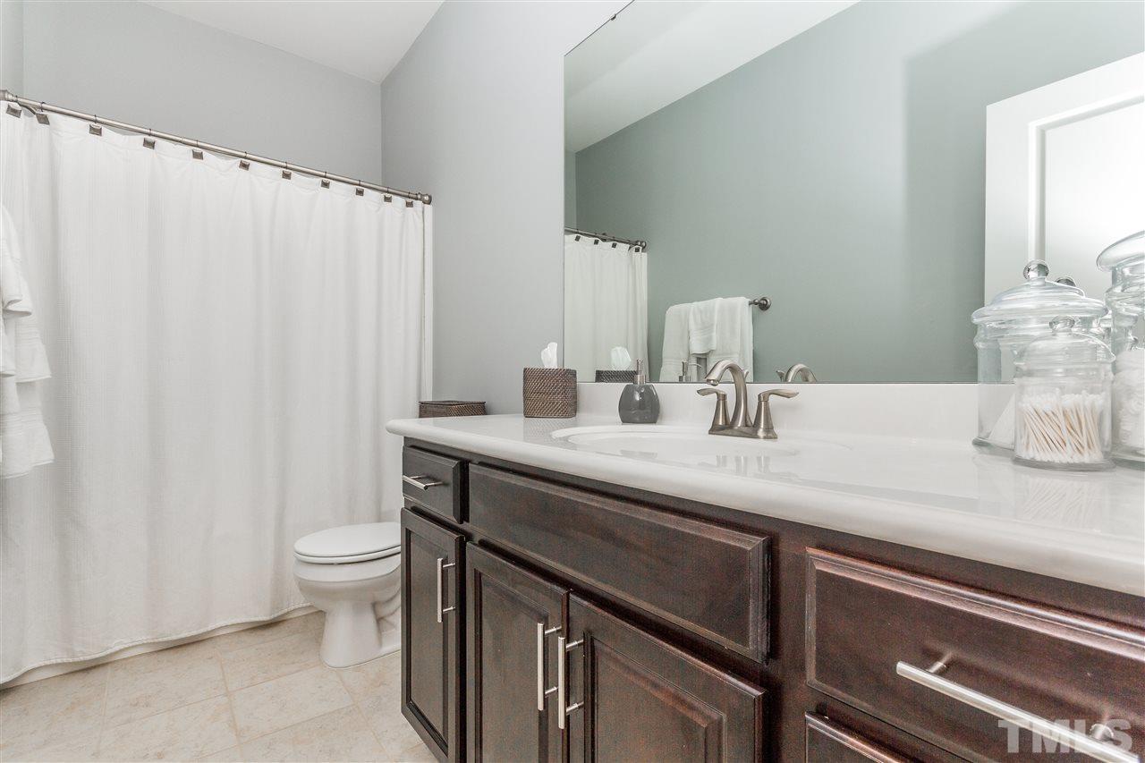 1325 Rodessa Run Raleigh, NC 27607 - Photo 19 of 25 a bathroom with a granite countertop sink and a mirror