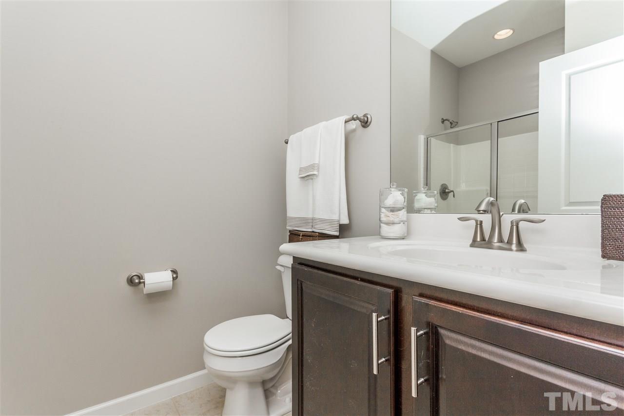 1325 Rodessa Run Raleigh, NC 27607 - Photo 24 of 25 a bathroom with a granite countertop toilet sink and mirror