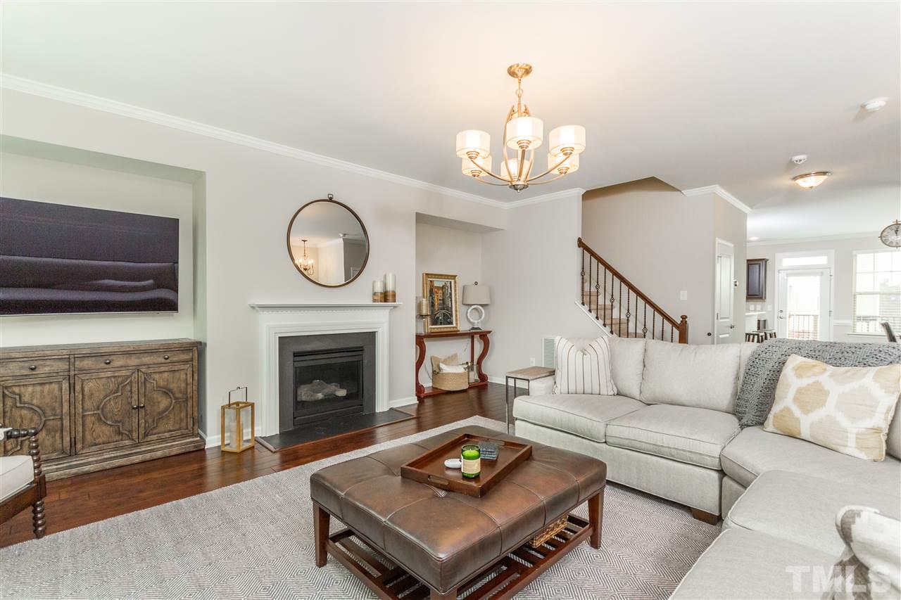 1325 Rodessa Run Raleigh, NC 27607 - Photo 5 of 25 a living room with furniture a fireplace and a flat screen tv