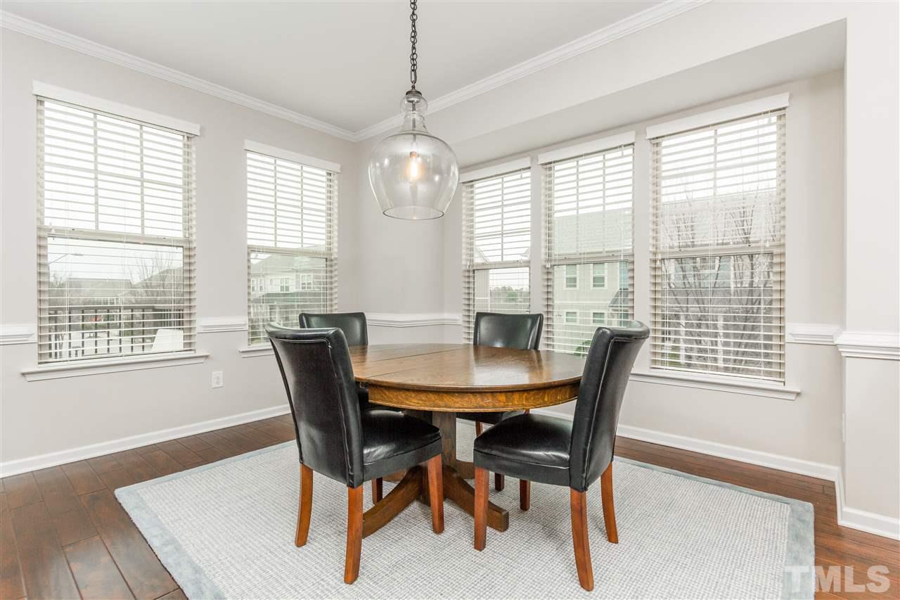 1325 Rodessa Run Raleigh, NC 27607 - Photo 10 of 25 a view of a dining room with furniture window and wooden floor