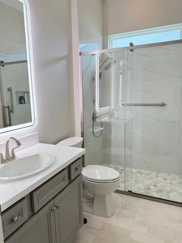 a bathroom with a sink toilet and shower