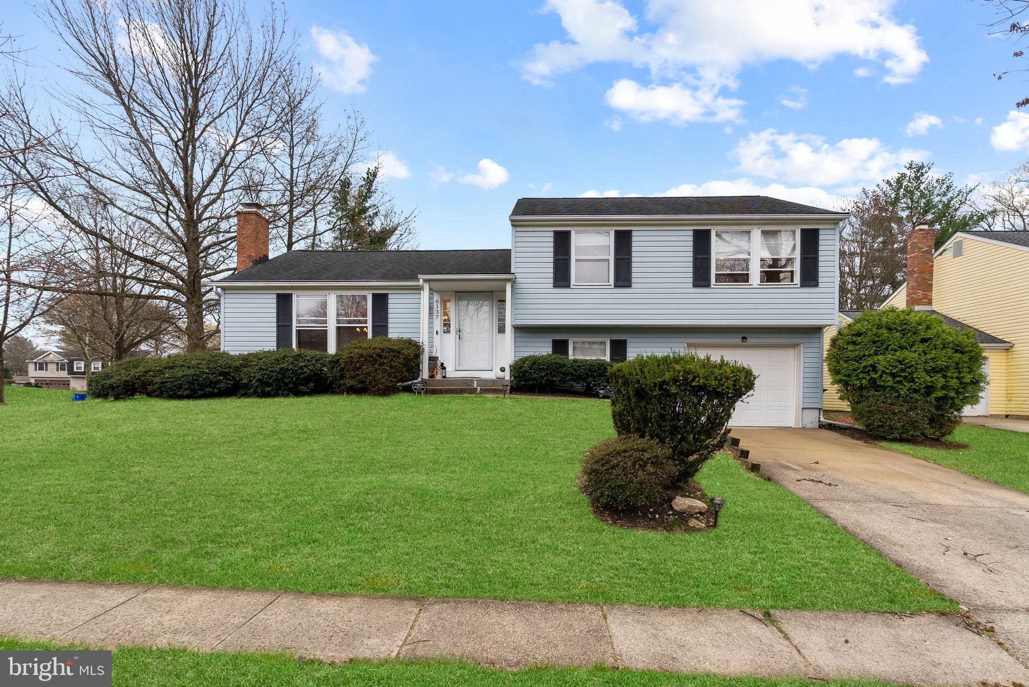 a view of a house with a backyard and a garden