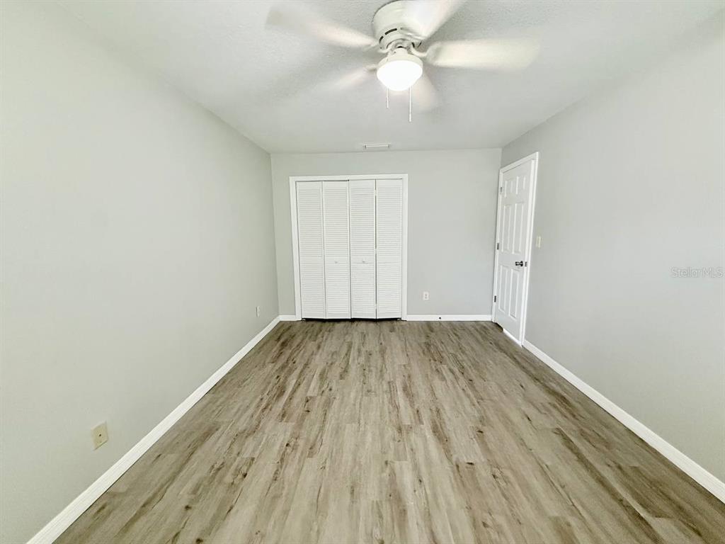 727 Milwaukee Avenue, Unit 6 Dunedin, FL 34698 - Photo 12 of 18 wooden floor in an empty room with a window