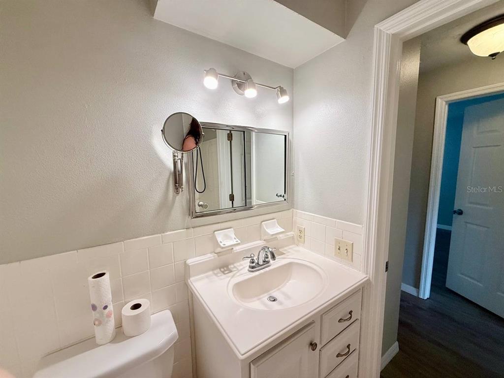 727 Milwaukee Avenue, Unit 6 Dunedin, FL 34698 - Photo 16 of 18 a bathroom with a sink and a mirror