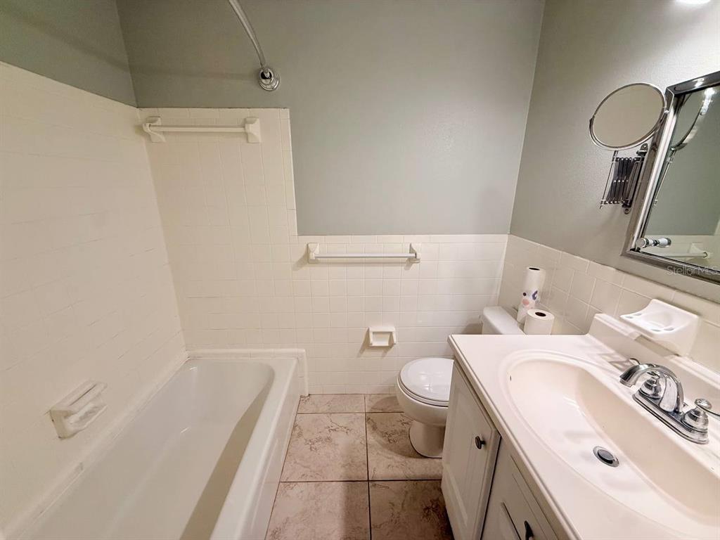 727 Milwaukee Avenue, Unit 6 Dunedin, FL 34698 - Photo 17 of 18 a bathroom with a sink a toilet and shower