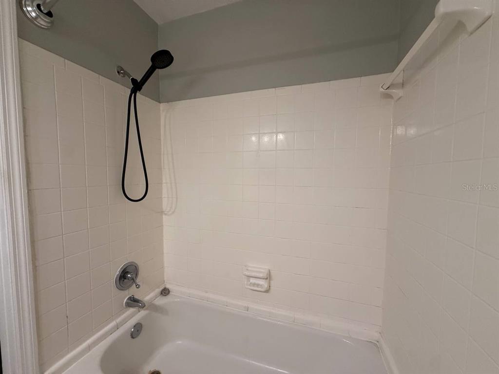 727 Milwaukee Avenue, Unit 6 Dunedin, FL 34698 - Photo 18 of 18 a bathroom with a bath tub with a shower