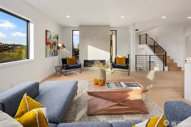 a living room with furniture and a floor to ceiling window