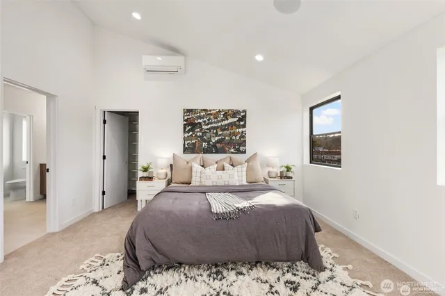 a bedroom with a large bed and a couch