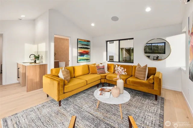 a living room with furniture and a wooden floor