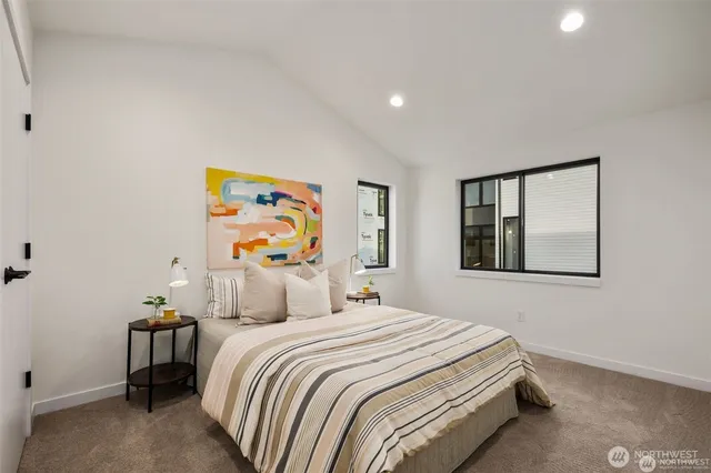 a bedroom with a bed and painting on the wall