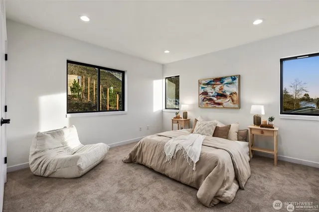 a bedroom with two beds and painting on the wall