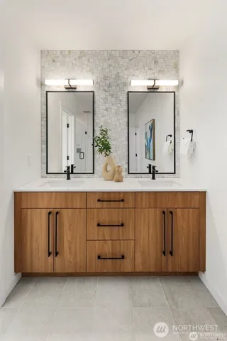 a bathroom with a double vanity sink and a mirror