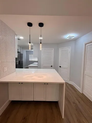 a large room with wooden floor and windows