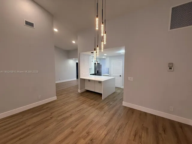 a view of a room with wooden floor and window