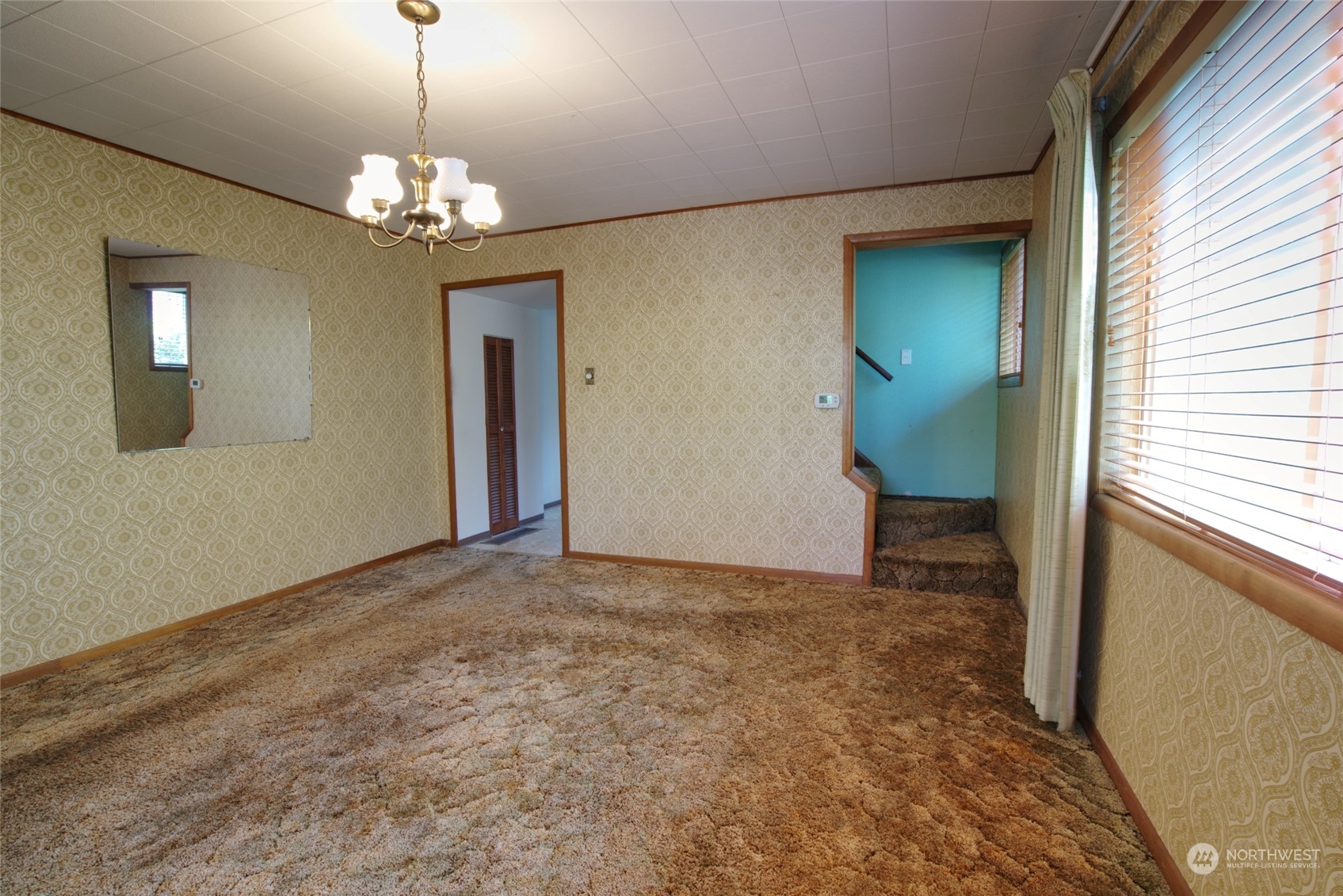 627 North Oakes Street Tacoma, WA 98406 - Photo 13 of 37 a view of a hallway with a chandelier and a window