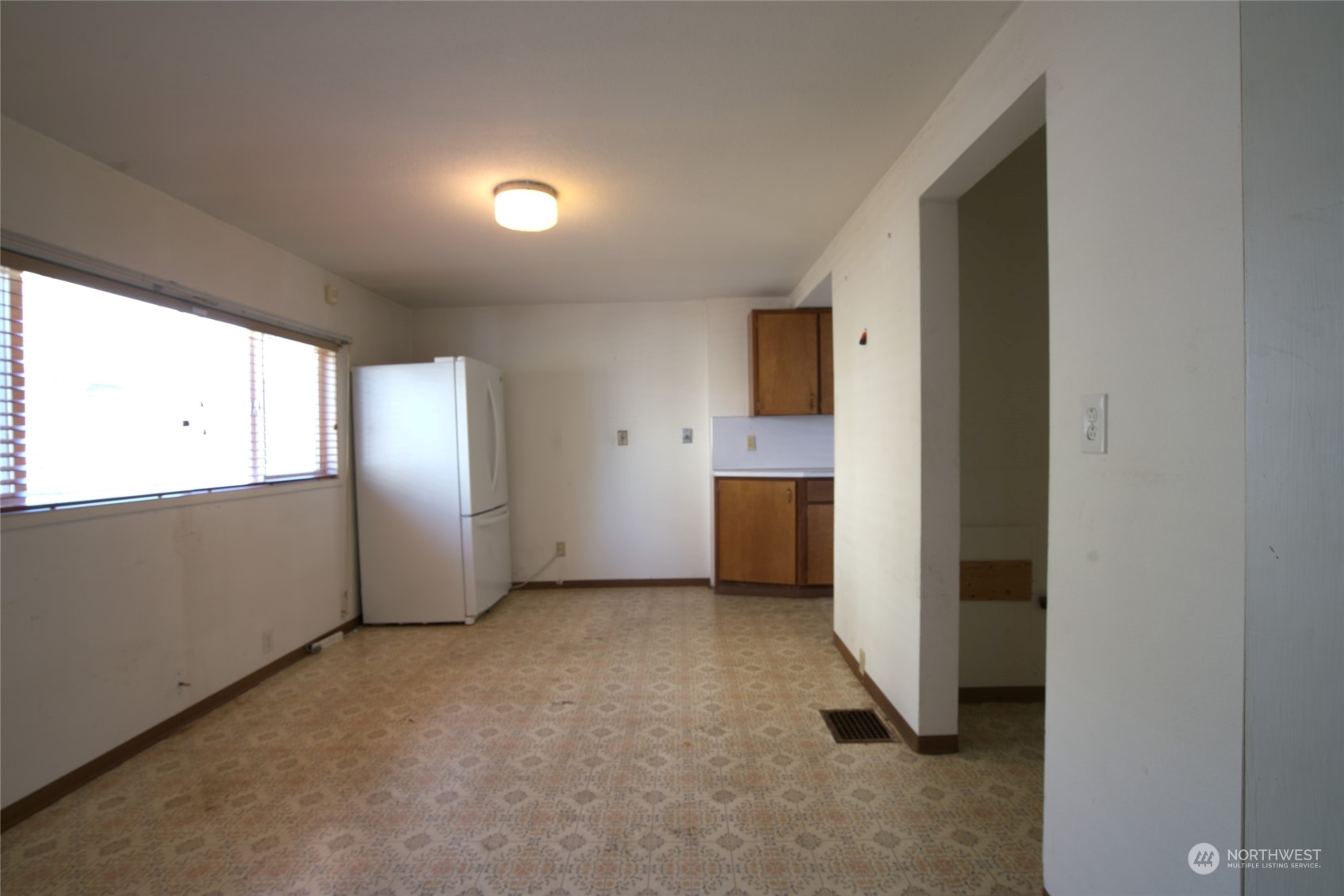 627 North Oakes Street Tacoma, WA 98406 - Photo 18 of 37 a view of a kitchen with a sink and a refrigerator