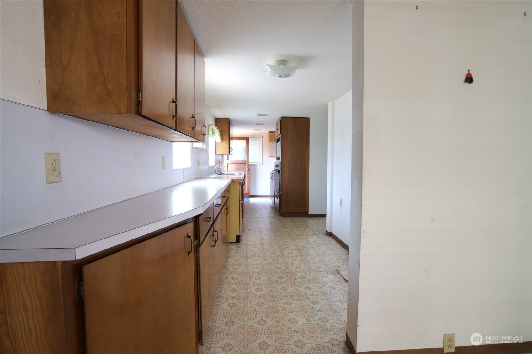 627 North Oakes Street Tacoma, WA 98406 - Photo 19 of 37 a kitchen with stainless steel appliances a refrigerator and cabinets