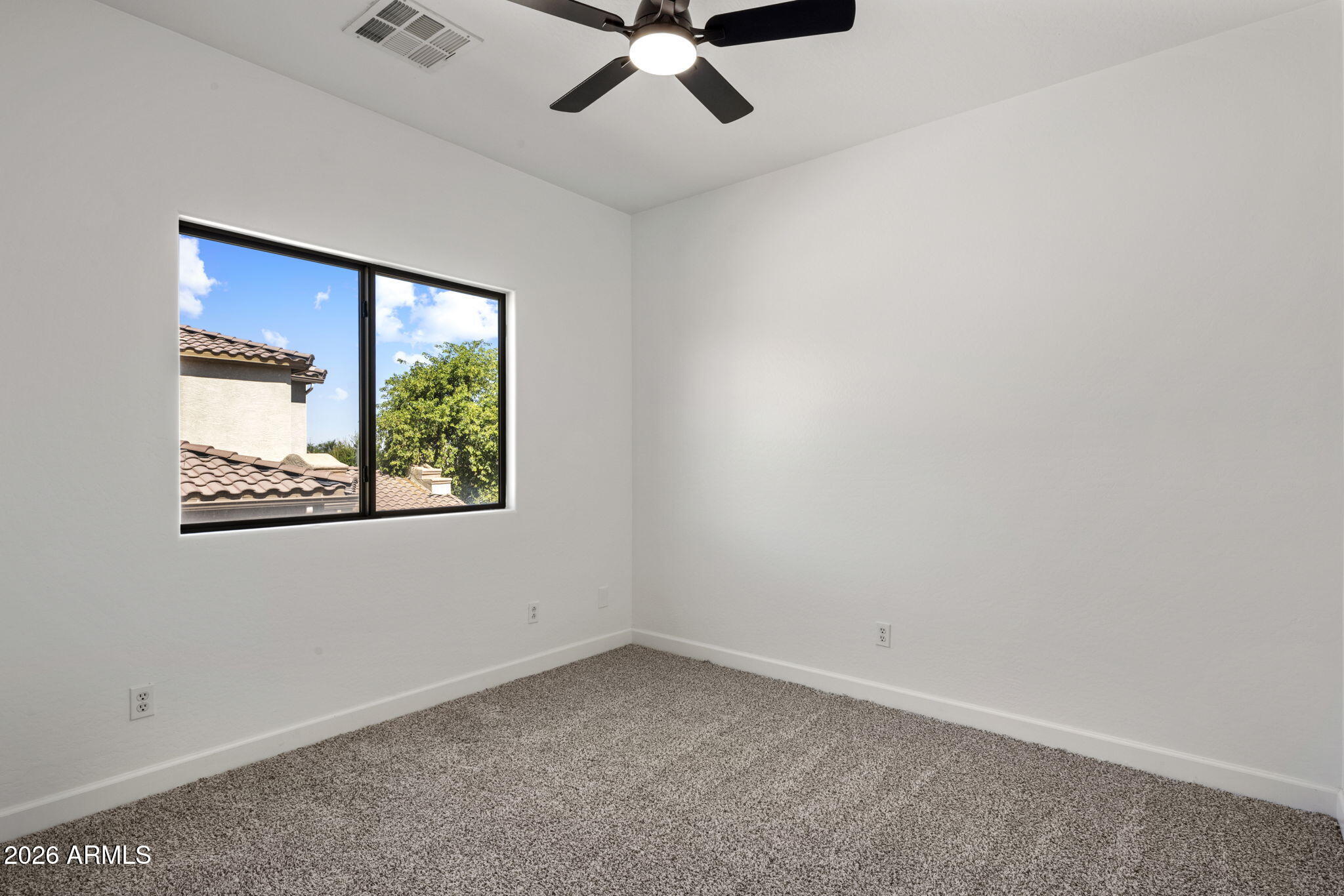 5121 West Beverly Road Laveen, AZ 85339 - Photo 24 of 32 an empty room with a window and ceiling fan