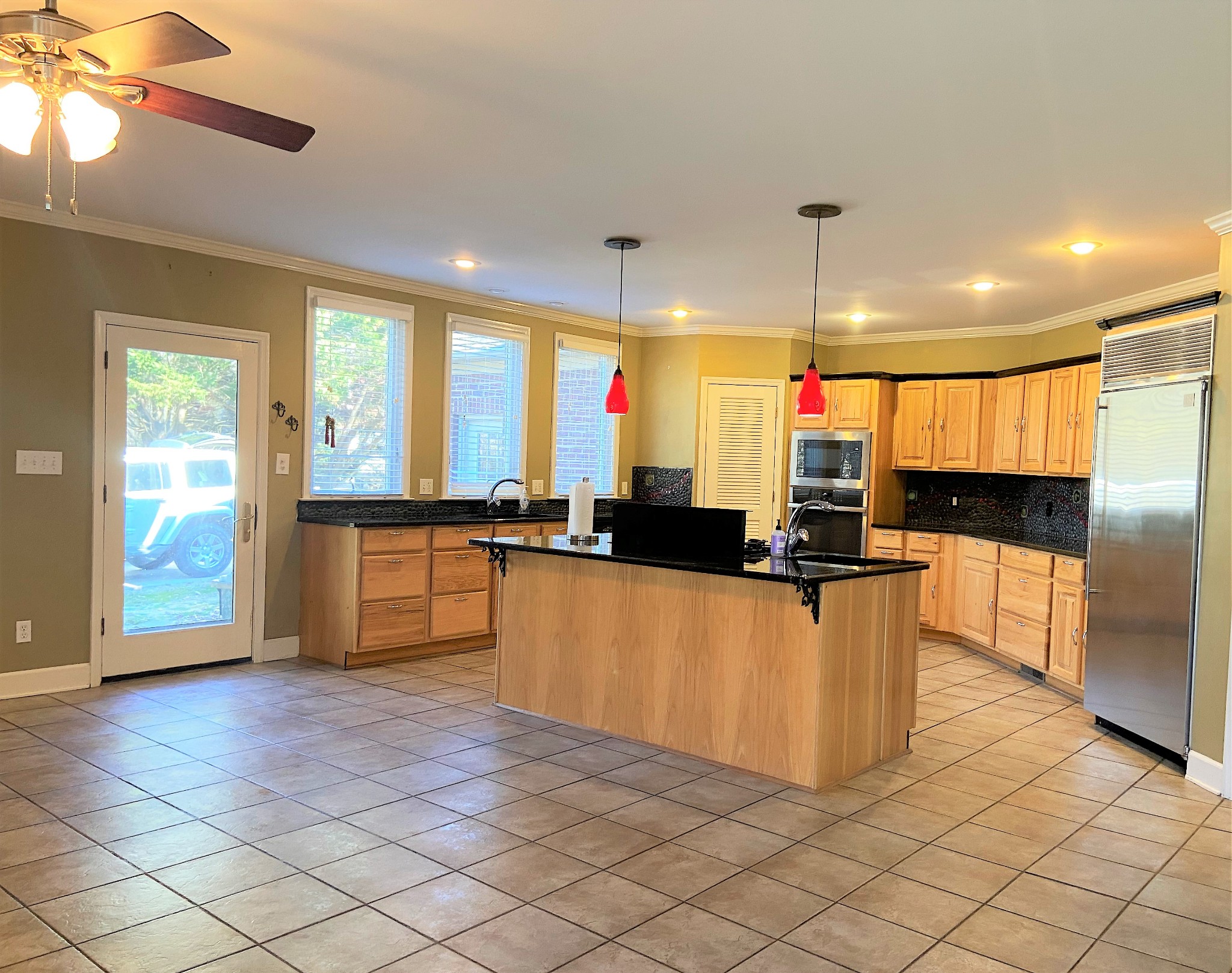 24695 Deer Ridge Lane Athens, AL 35613 - Photo 19 of 49 a kitchen with stainless steel appliances kitchen island granite countertop a refrigerator and a sink