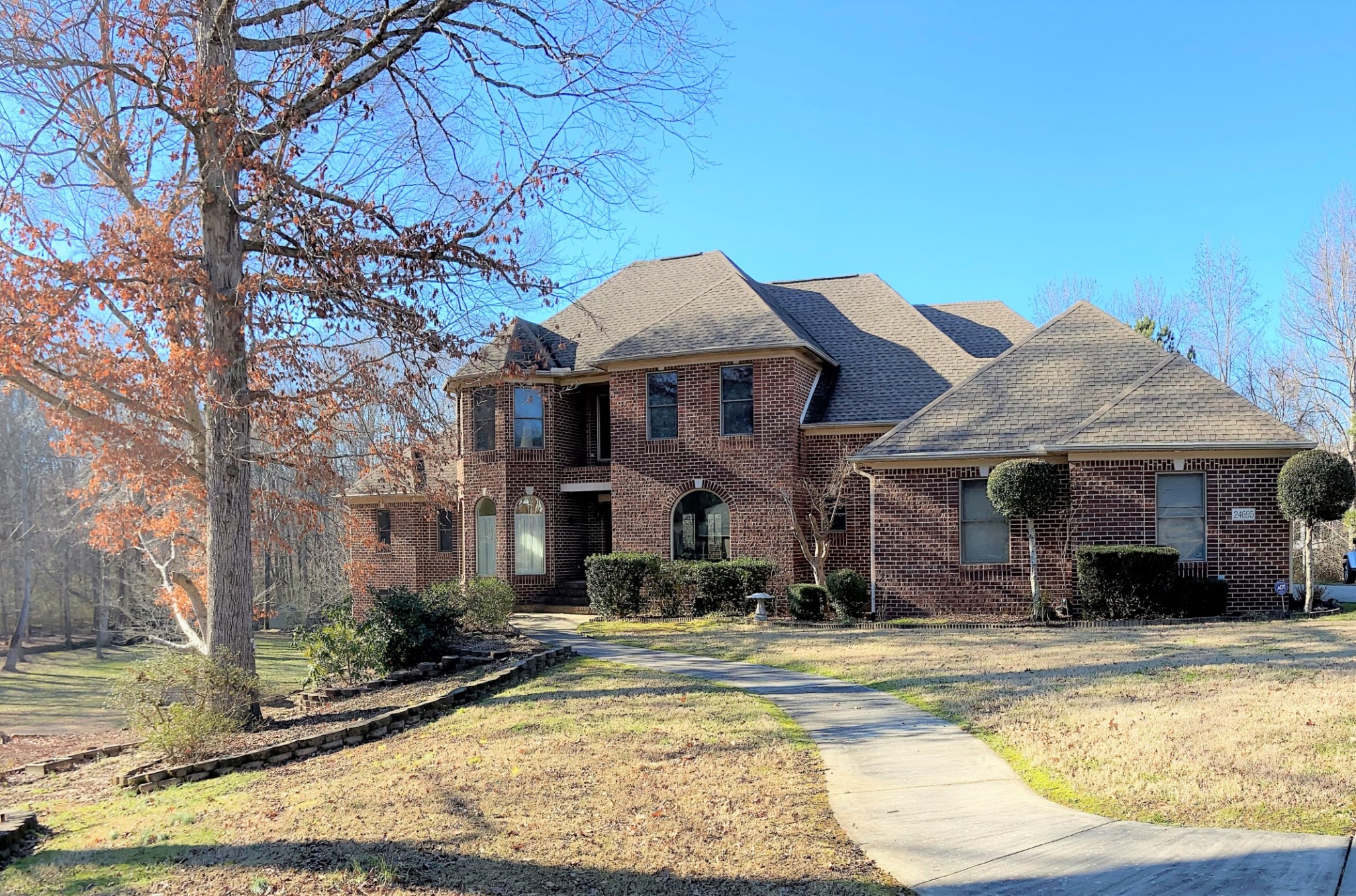 24695 Deer Ridge Lane Athens, AL 35613 - Photo 3 of 49 a view of a white house with a swimming pool and a chairs and tables in a patio