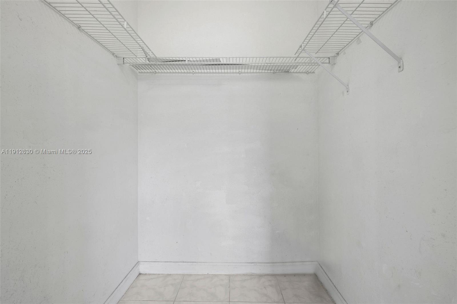 1658 Southeast 28th Court, Unit 200 Homestead, FL 33035 - Photo 12 of 20 a view of a room with racks on the wall