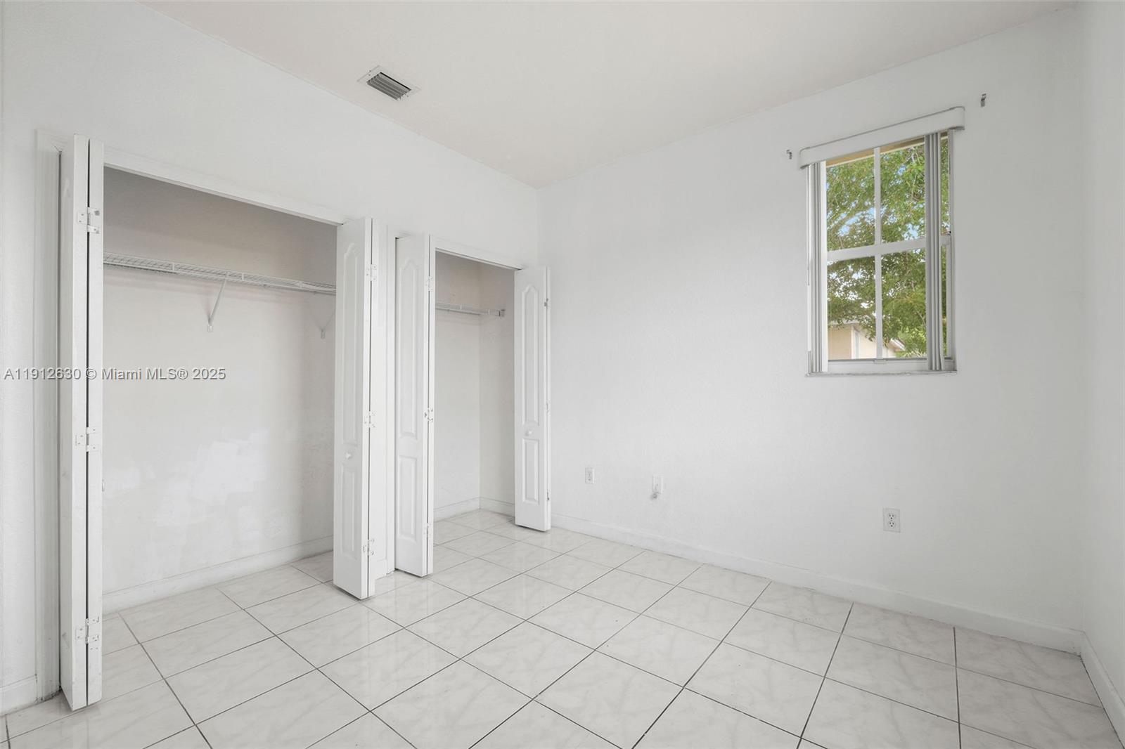 1658 Southeast 28th Court, Unit 200 Homestead, FL 33035 - Photo 15 of 20 an empty room with windows