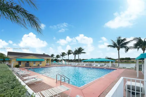 a view of swimming pool with outdoor seating and lake view