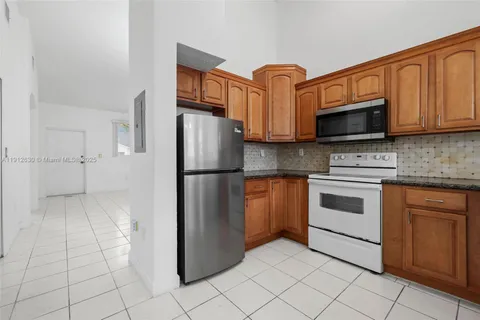 a kitchen with cabinets stainless steel appliances and a sink
