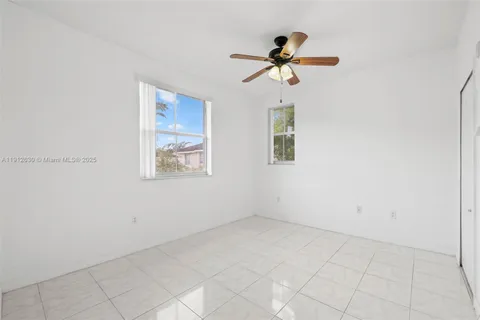 a view of empty room with ceiling fan