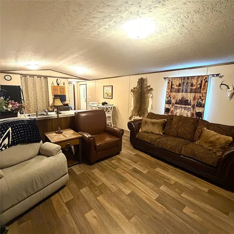 a kitchen with granite countertop a refrigerator stove and cabinets