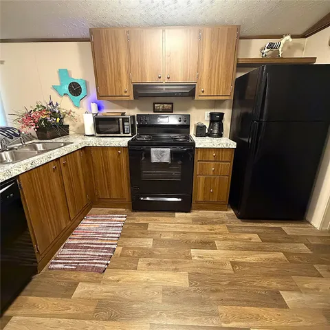 a bathroom with a granite countertop sink mirror vanity and toilet