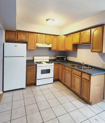 a kitchen with stainless steel appliances granite countertop a stove a sink dishwasher and a refrigerator
