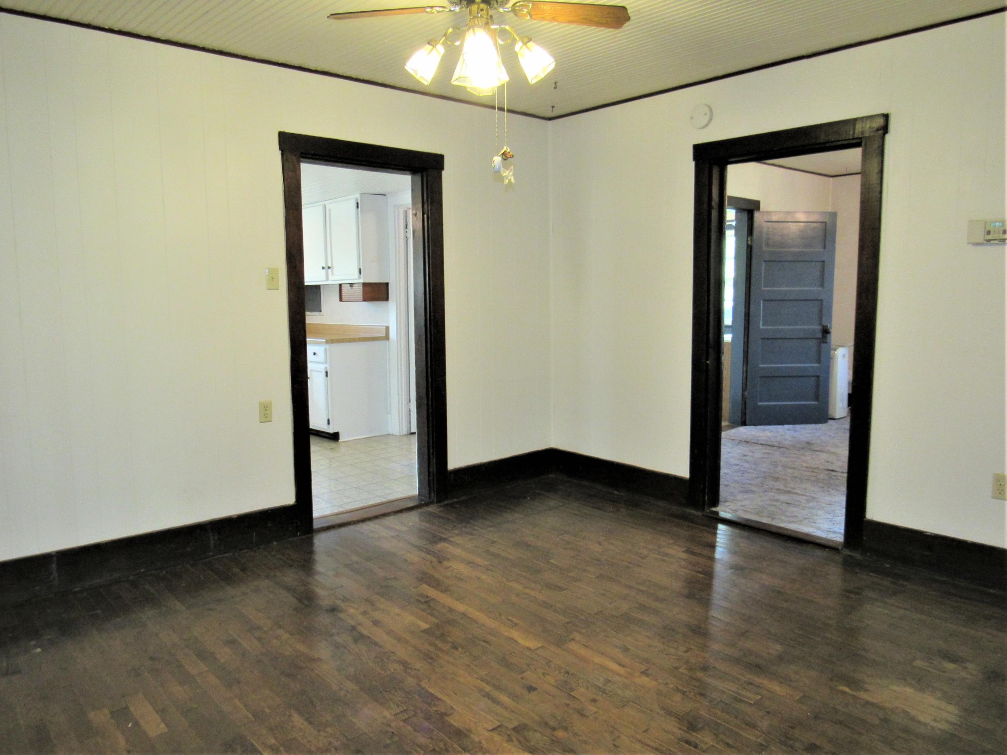 119 Andy Cooper Road Lancing, TN 37770 - Photo 13 of 35 an empty room with wooden floor and a ceiling fan