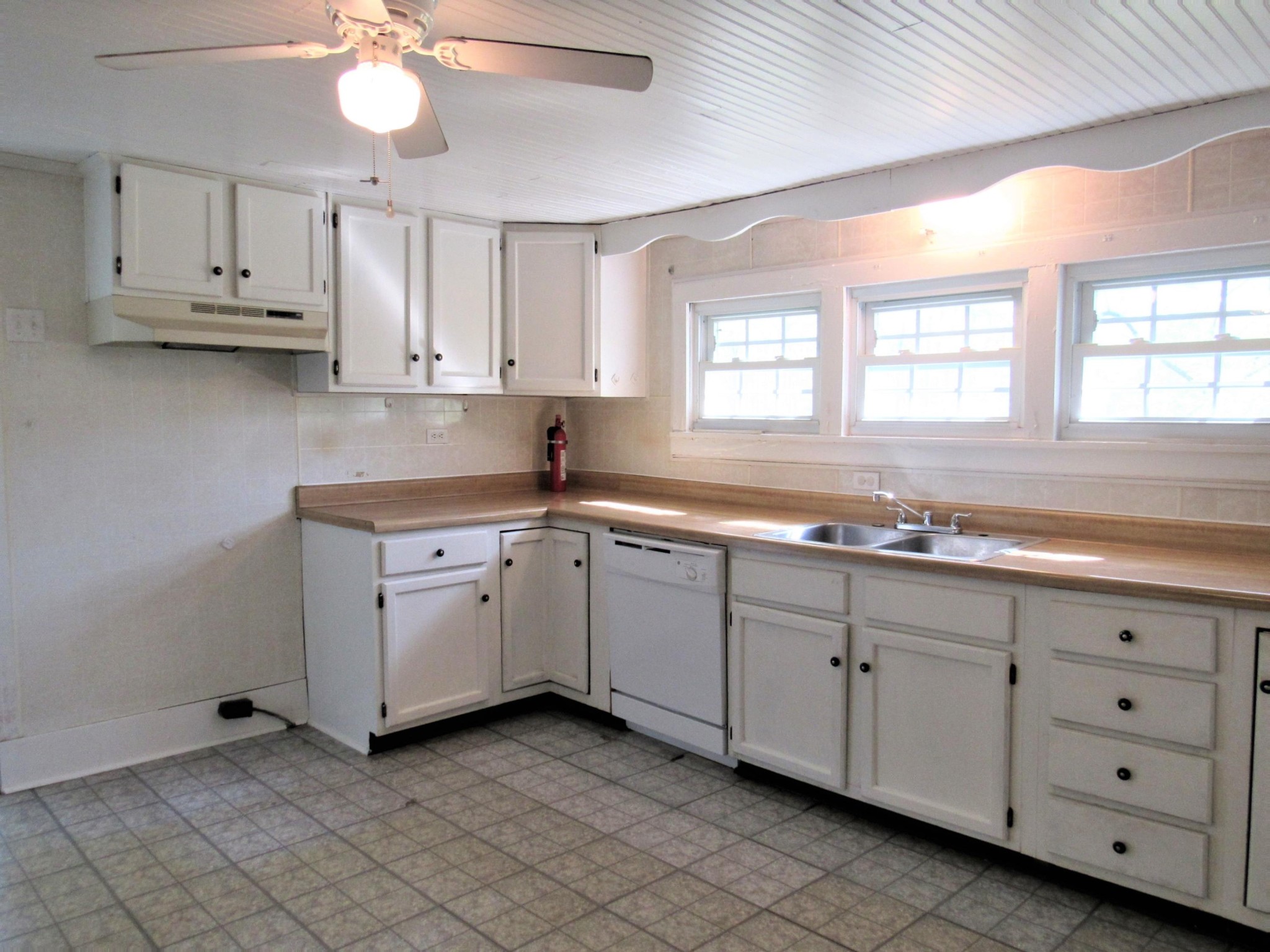 119 Andy Cooper Road Lancing, TN 37770 - Photo 5 of 35 a kitchen with sink cabinets and window