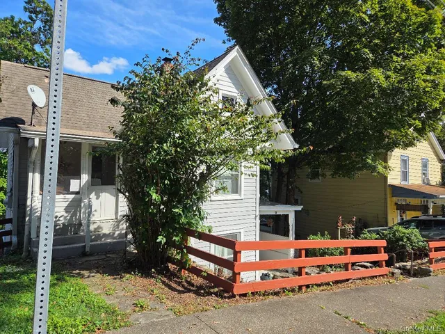 a backyard of a house with table and chairs