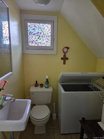 a view of bathroom with a sink and mirror