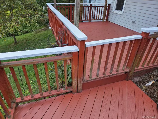 a balcony with wooden floor in front of it