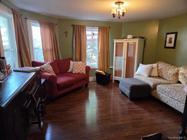 a living room with furniture and a chandelier
